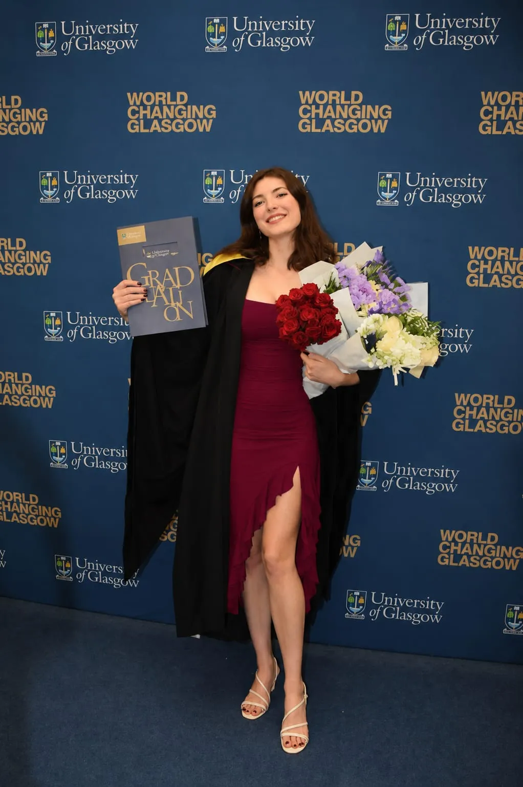 Woman wearing a sleek sleeveless bodycon midi dress for a modern graduation dress look