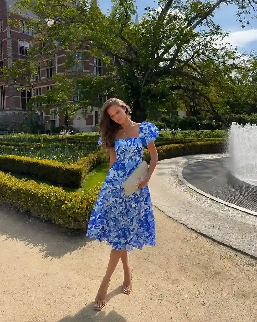 Blue floral puff sleeve midi dress styled with brown strappy heels, perfect for garden graduation celebrations.
