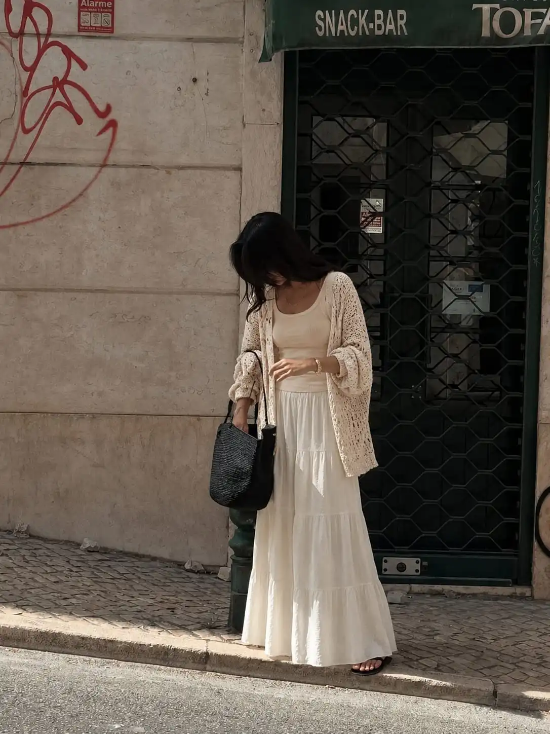 Feminine summer outfit featuring a crochet cardigan layered over a ribbed tank top and flowy maxi skirt for cooler evenings.
