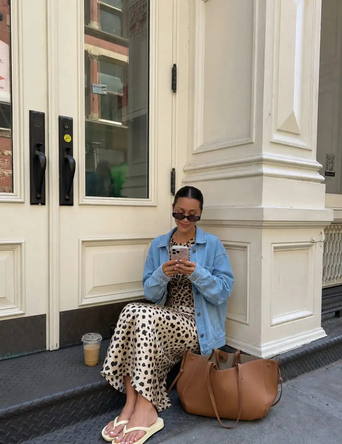 Stylish summer evening outfit with an oversized denim jacket, leopard print maxi skirt, and fitted t-shirt.
