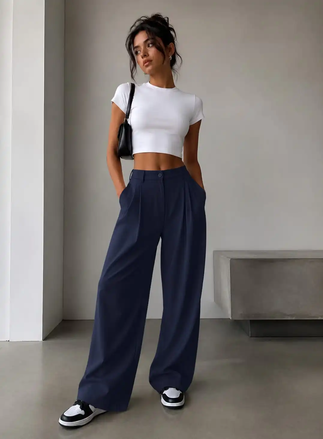 Woman wearing navy wide leg trousers with a fitted white T-shirt for a simple and elegant summer outfit idea.