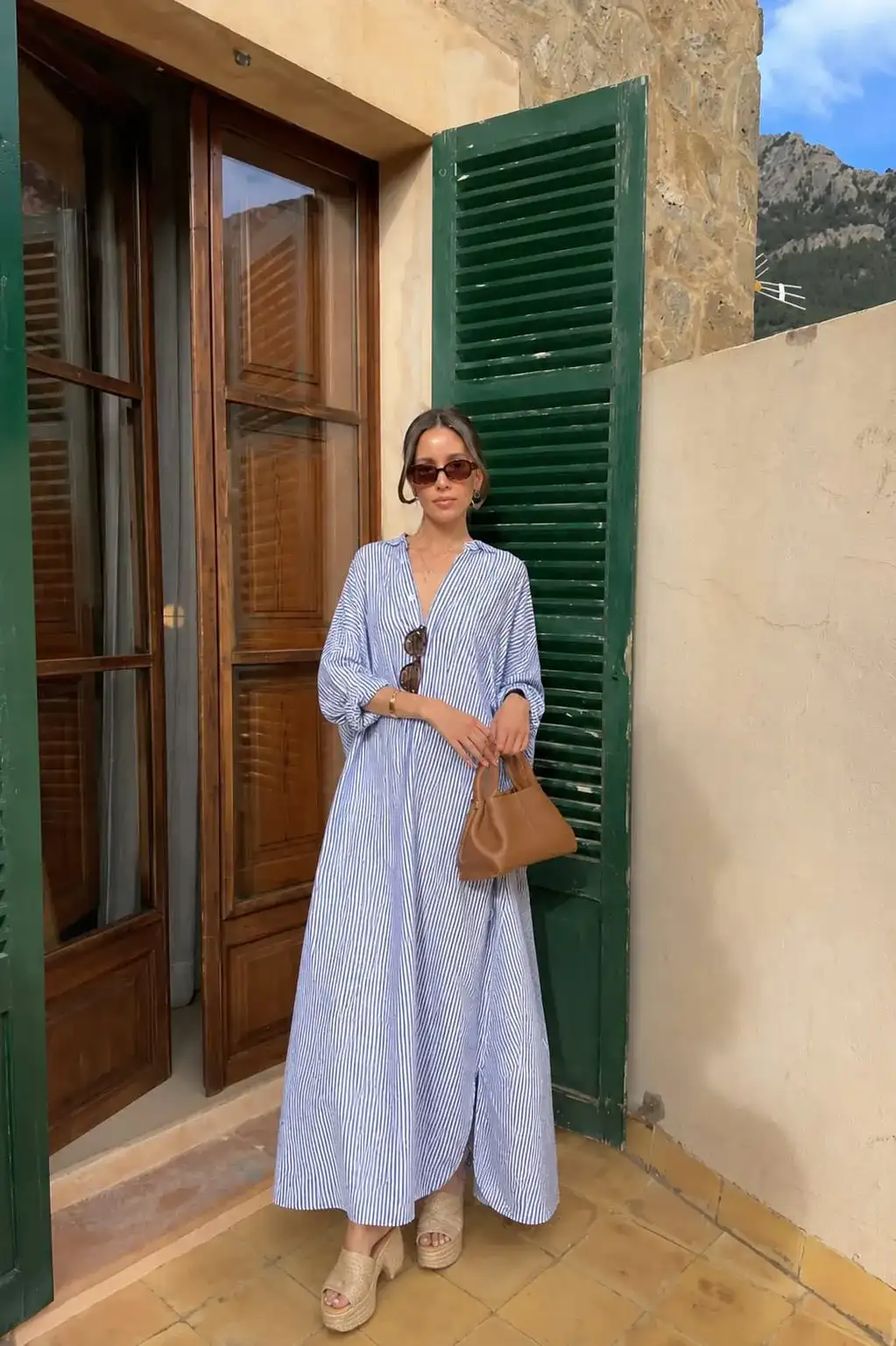 Blue striped maxi shirt dress paired with platform espadrille sandals for a comfortable graduation guest outfit.