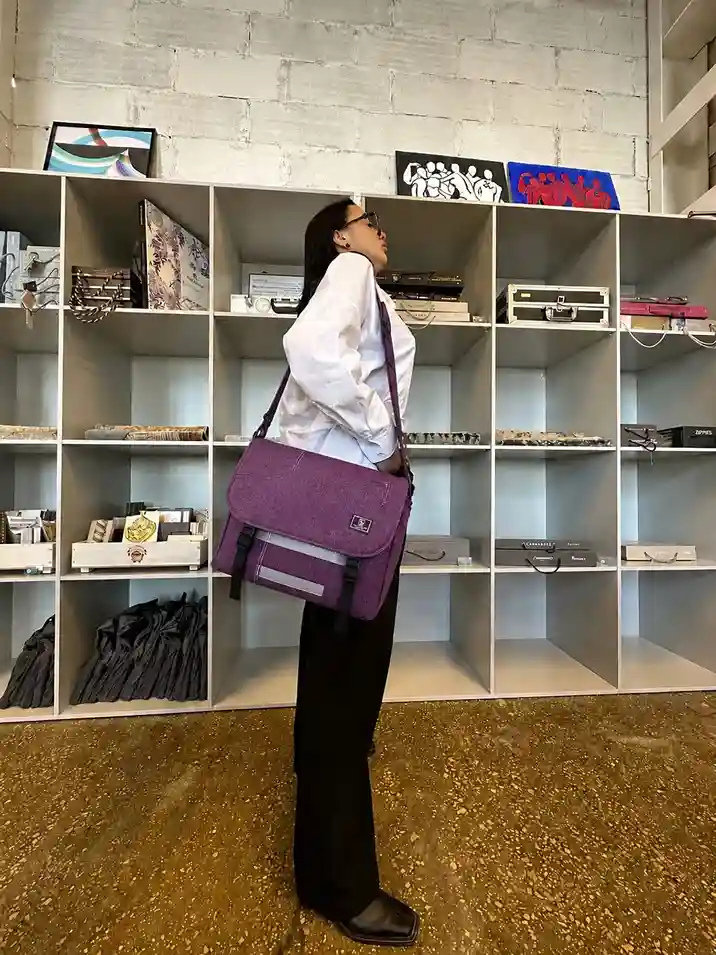 Person carrying a stylish messenger bag with a modern designer-inspired look, perfect for work, college, and everyday commuting