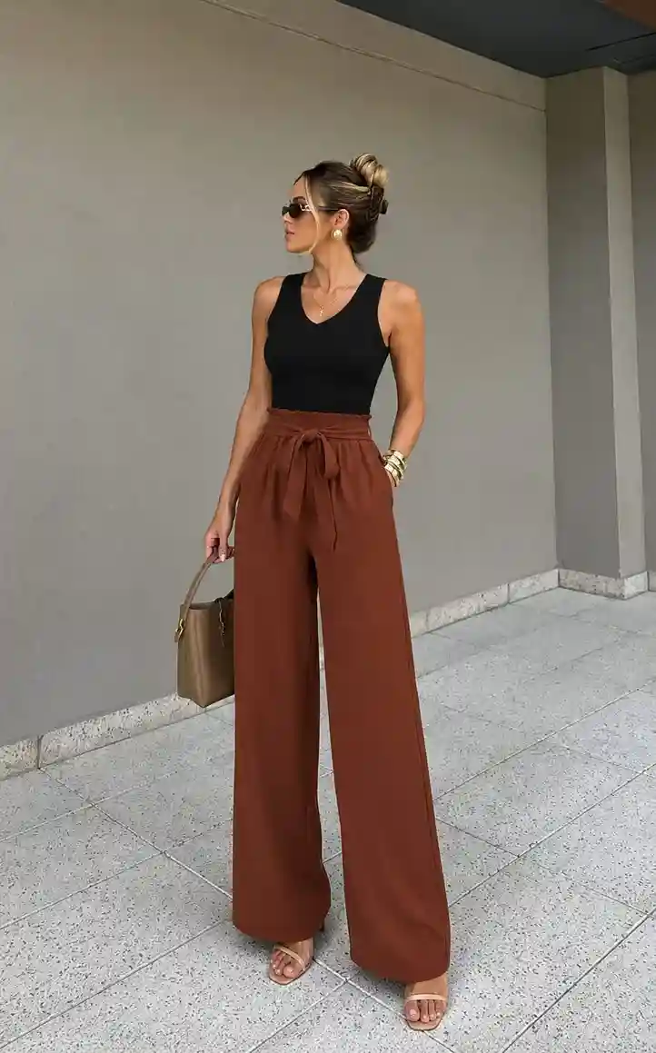 Black ribbed tank top styled with brown wide-leg trousers creating a chic graduation guest outfit alternative to dresses.