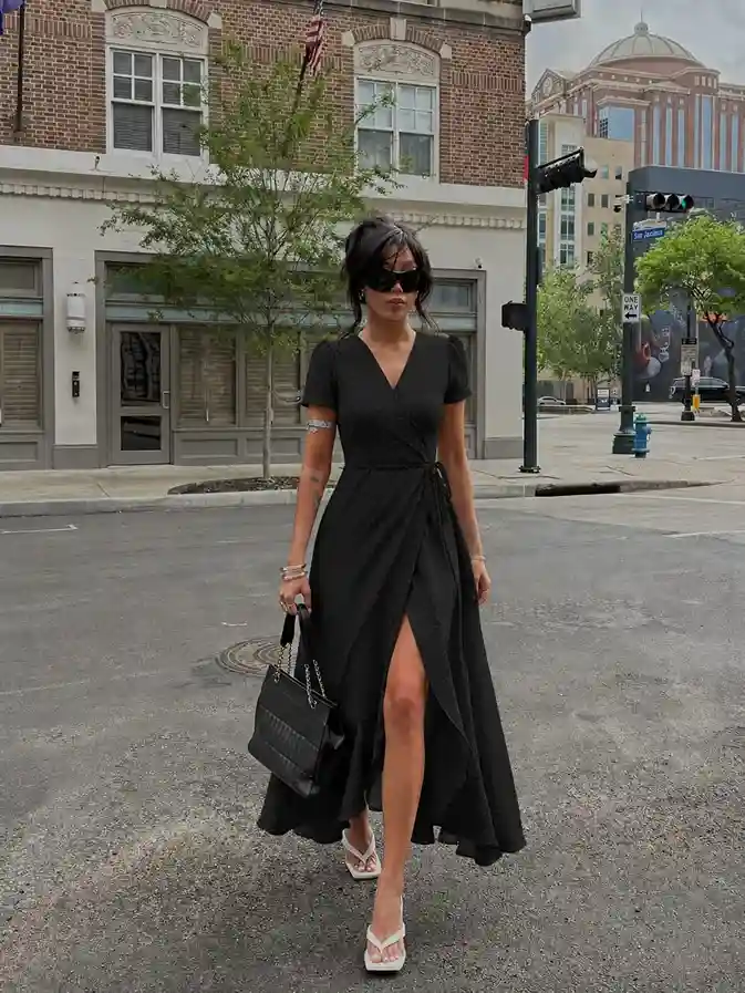 Woman wearing a black wrap maxi dress styled for dinner, parties, and classy affordable fashion.