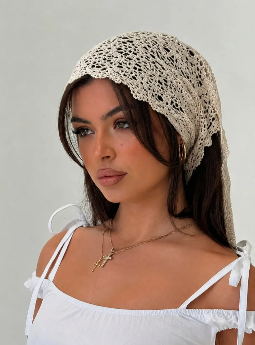 Woman wearing a floral lace glossy satin bandana with a white off-shoulder top, showcasing a stylish Amazon head scarf for casual summer outfits.